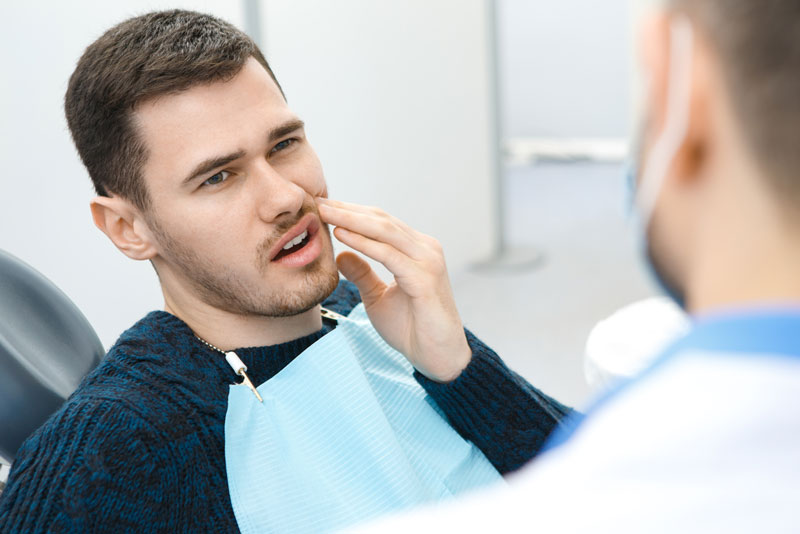 Dental Patient Suffering From Mouth Pain In The Dental Chair